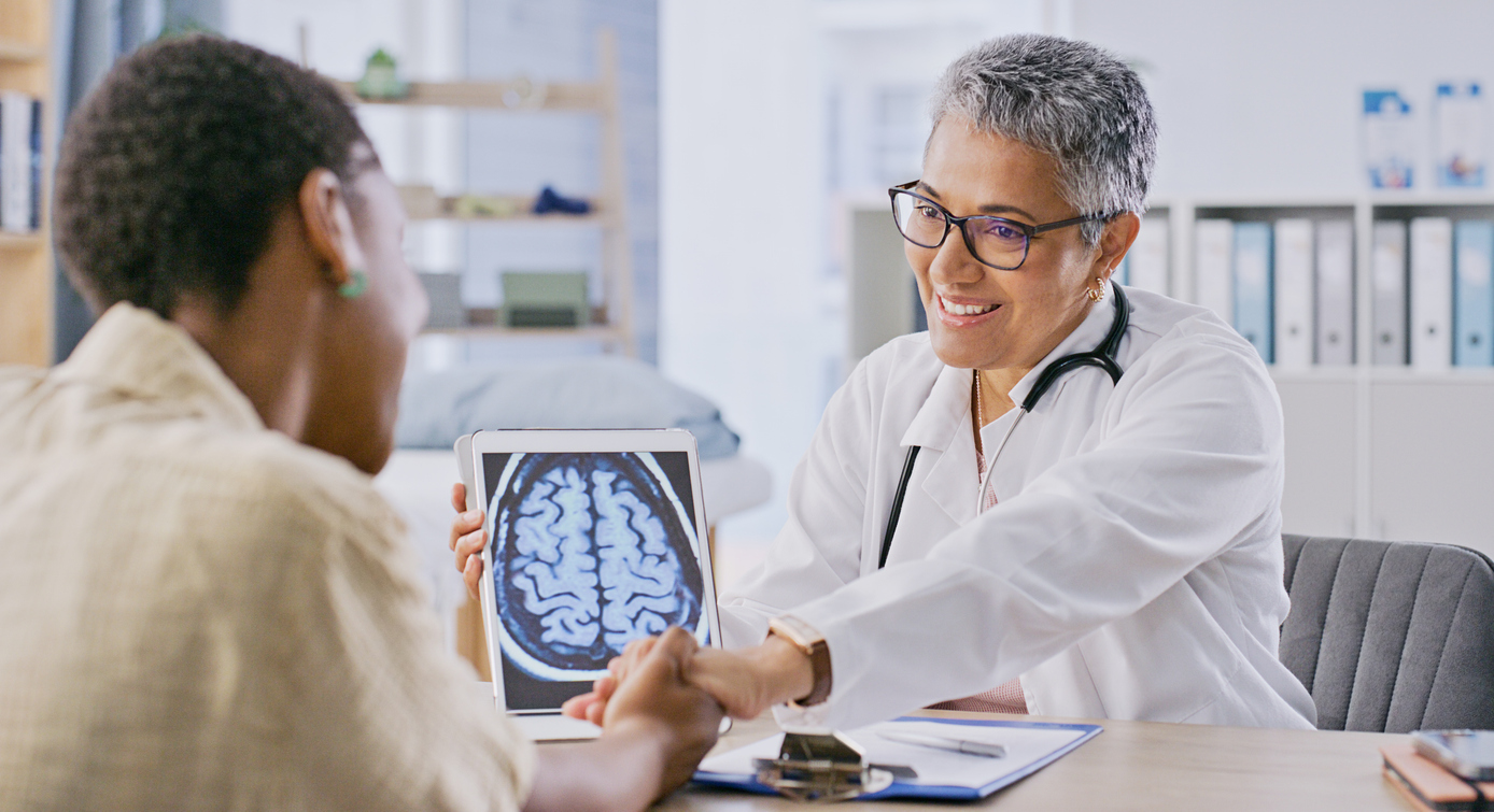 Doctor showing human brain scan to patient 