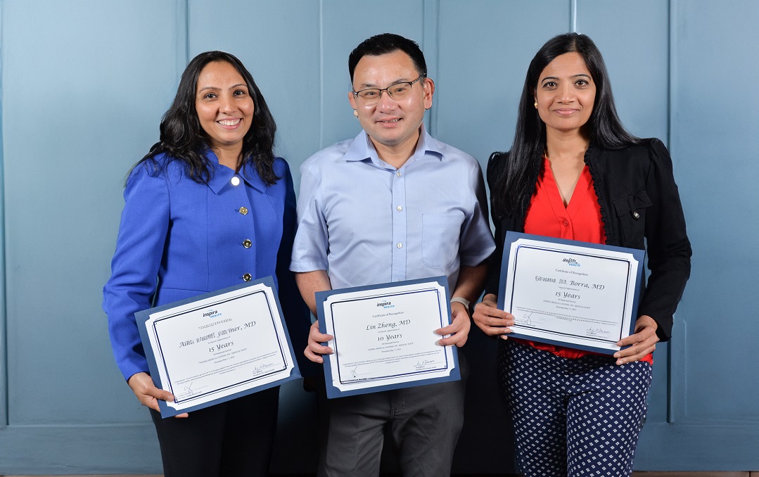 Doctors standing with their certifications