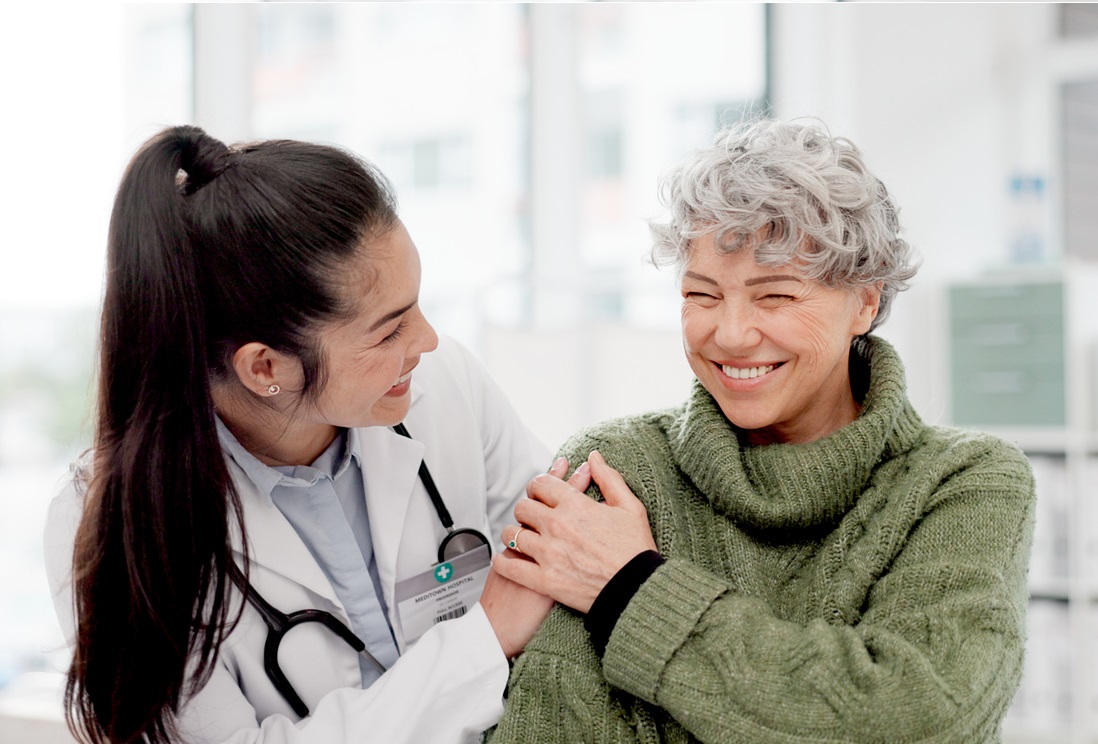 Doctor cheering up female patient