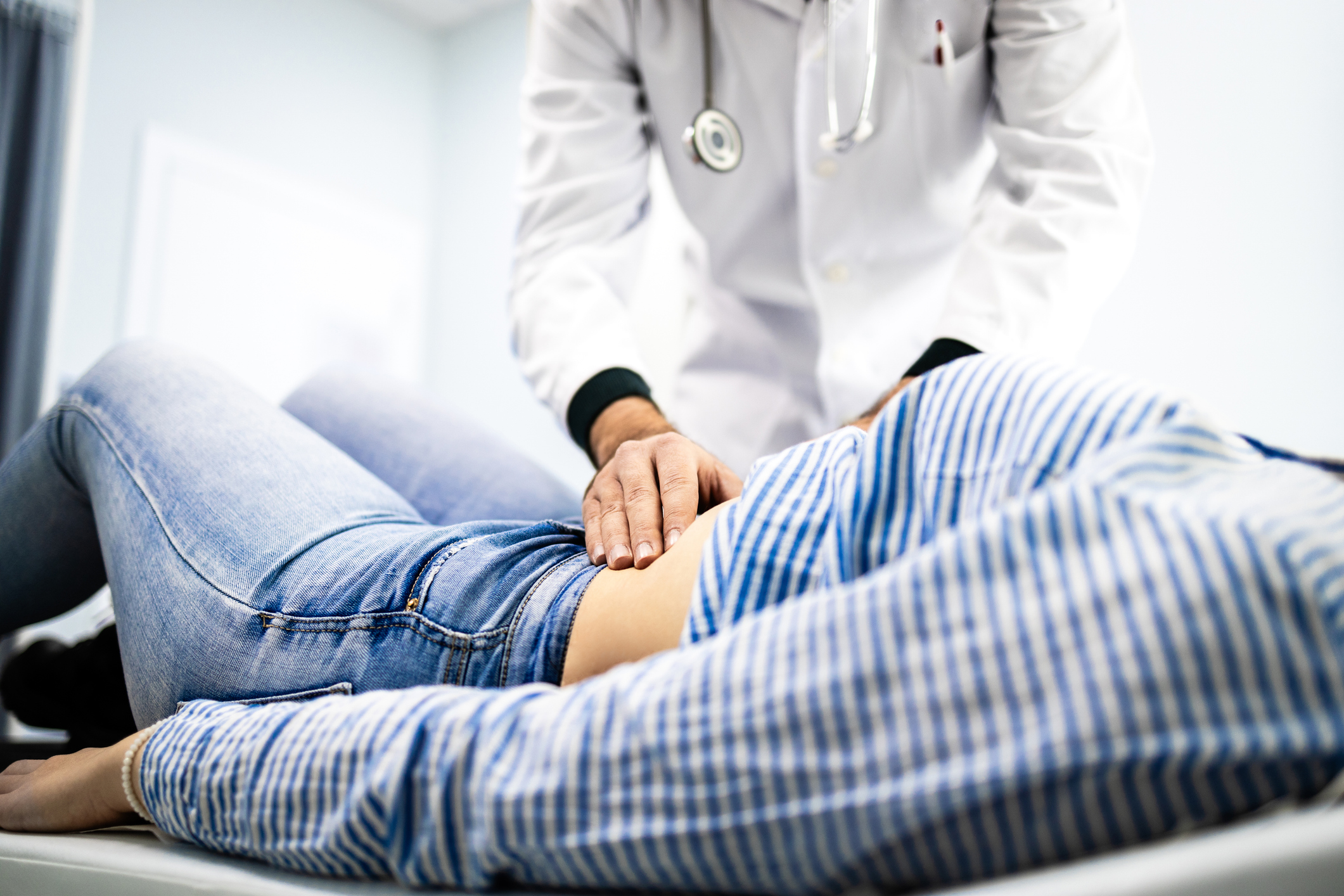 Gastroenterologist examining female patient's stomach