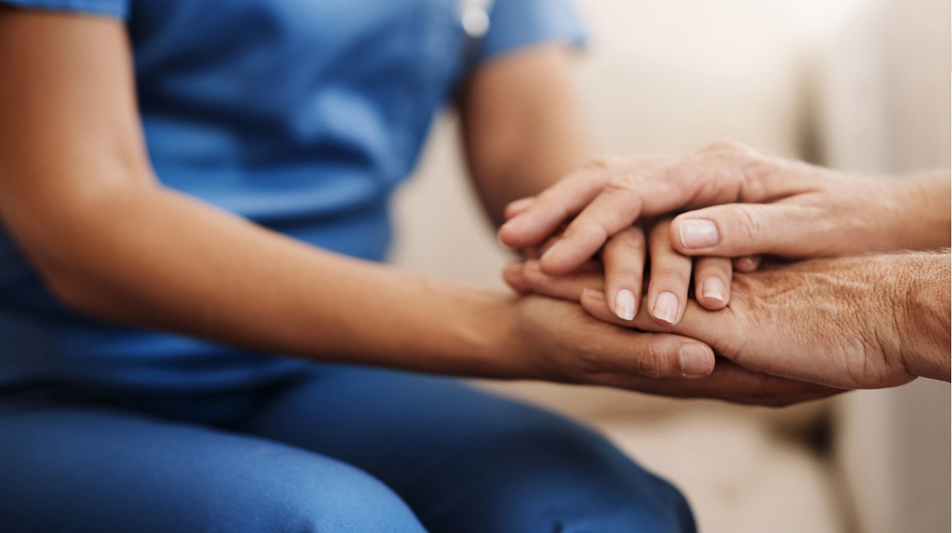 Doctor holding patient's hands