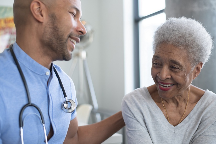 Male doctor with elderly patient