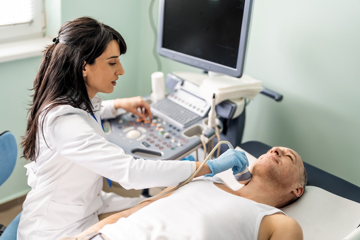 Doctor checking patient's thyroid gland