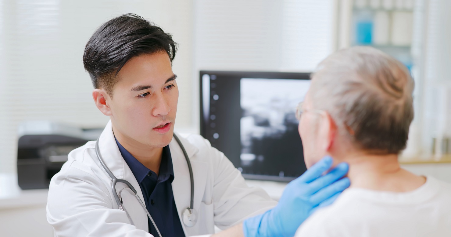 Doctor checking patient's thyroid gland