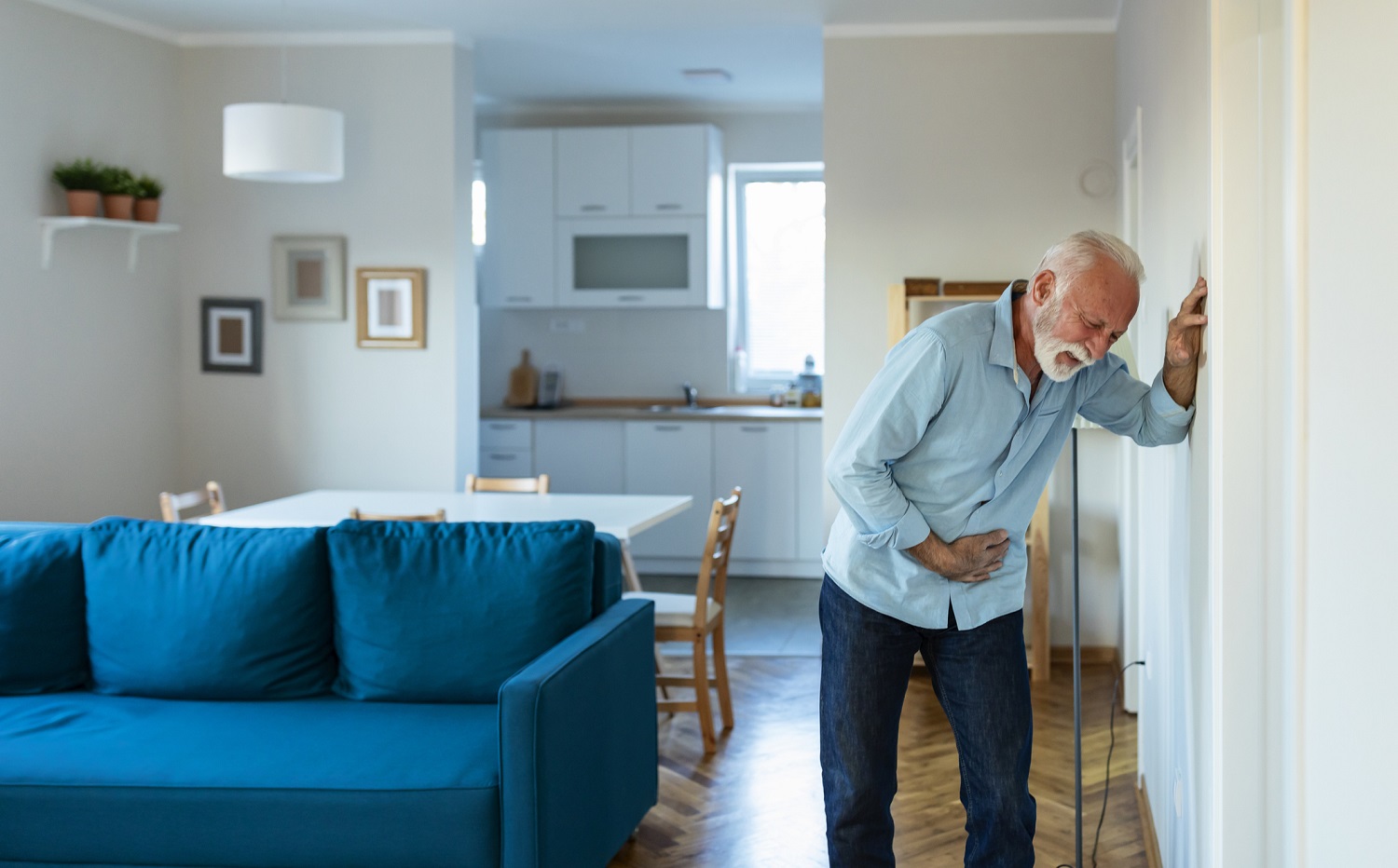 Elder man holding bladder