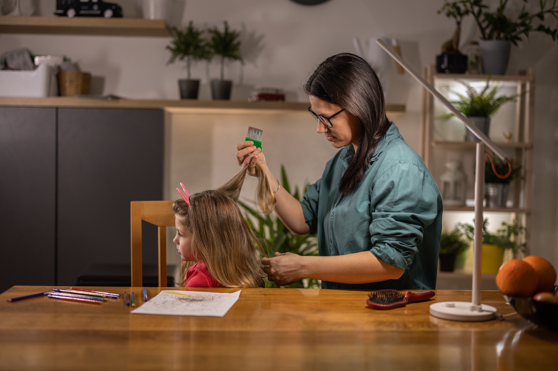 mom combing daughter's hair