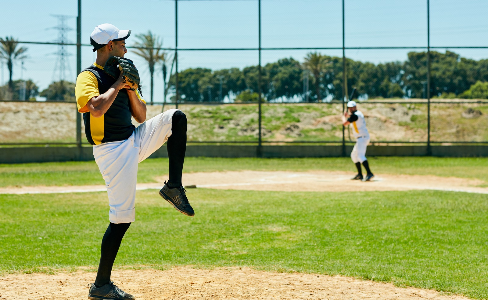 Shot of a young man pitching a ball during a baseball match