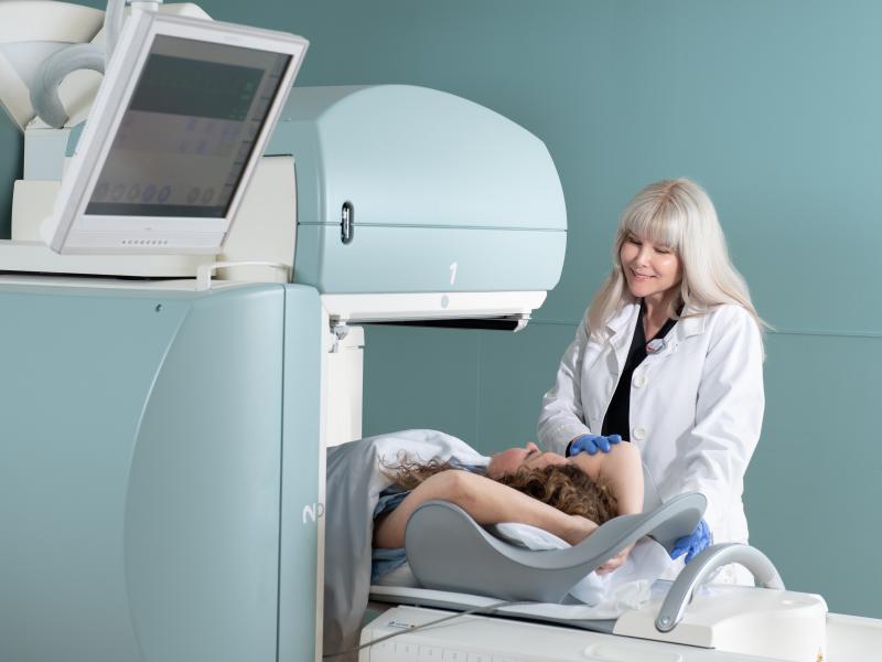 patient being placed into imaging machine by physician