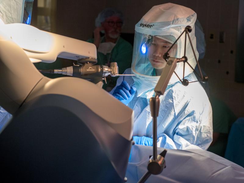 A surgeon performing orthopedic surgery