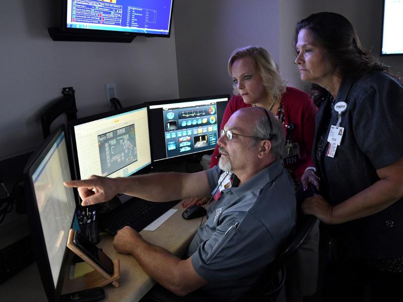 Capacity Command Center - man pointing at computer screen with two women looking on