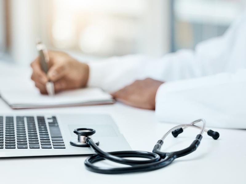 Doctor reviewing patient information on laptop