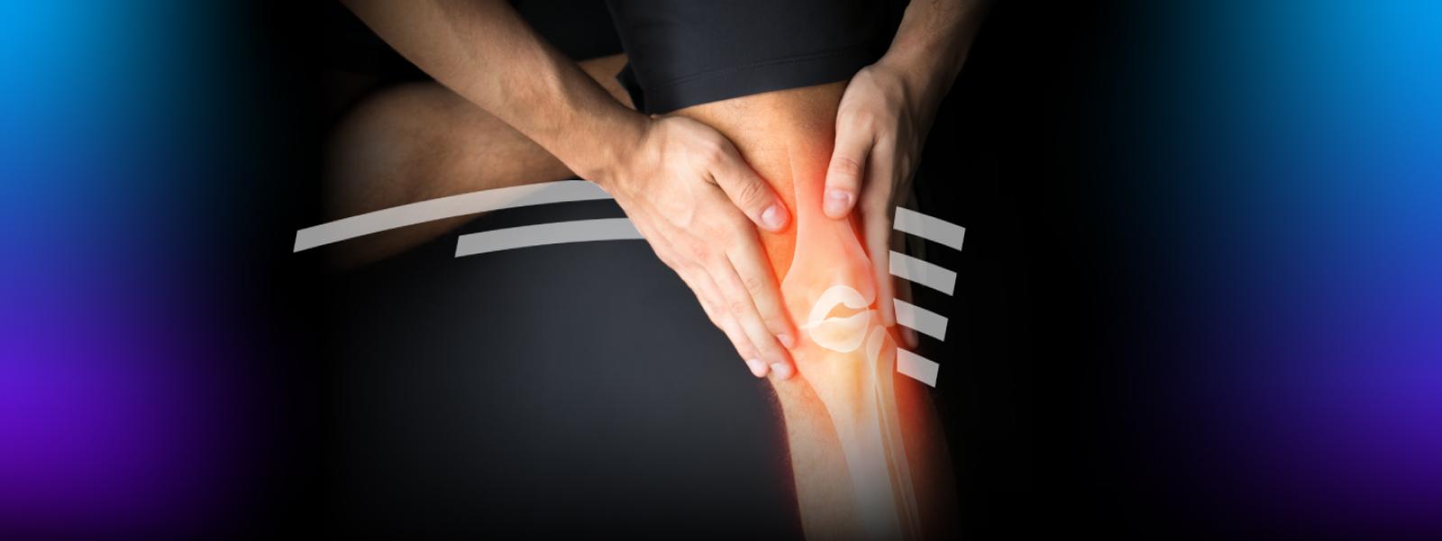 Person holding knee with ligaments