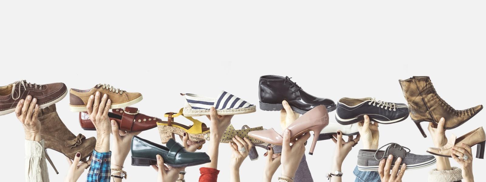 Image of people holding shoes in the air