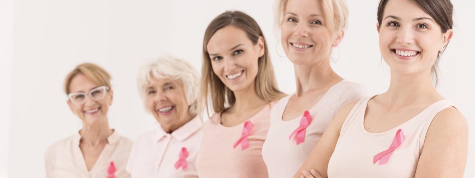 5 women wearing breast cancer awareness ribbons