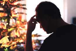 Unhappy, lonely or tired man with stress, grief or depression sad on Christmas.
