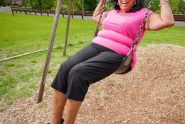 Senior woman enjoying a swing in the garden