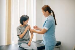nurse giving injection to the child