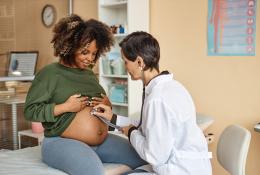 Doctor checking belly of a pregnant woman