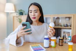 Woman holding a magnesium supplement bottle.