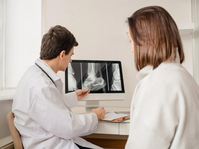 Orthopedic Surgeon Explaining X-Ray to Women