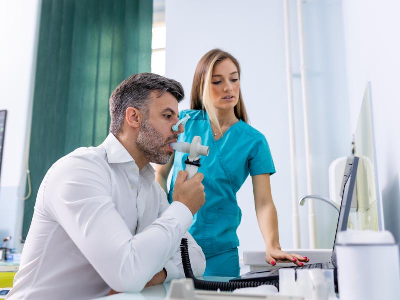 man taking spirometry test for COPD conditions in hospital