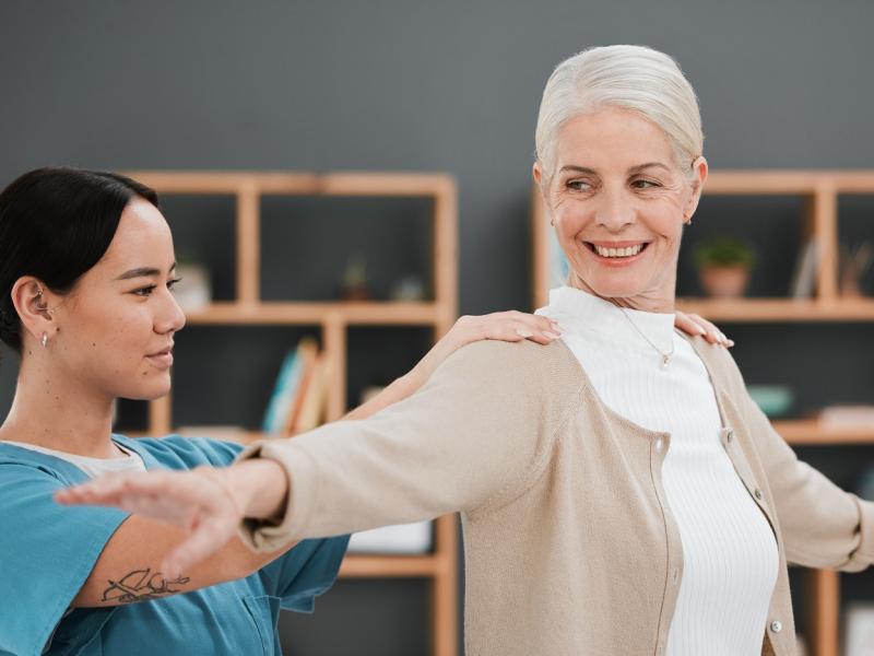 occupational therapist works with an elderly woman