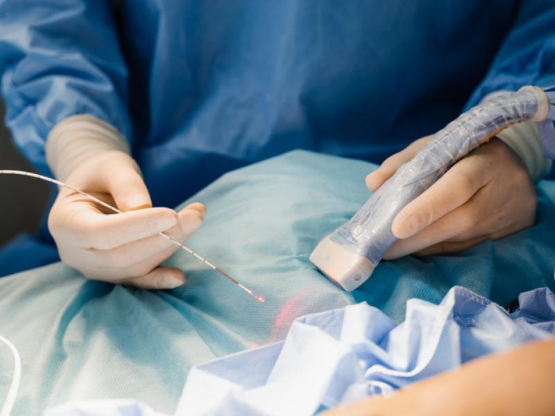 Doctor doing laser therapy on patient