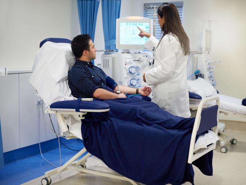 Doctor performing Hemodialysis on patient