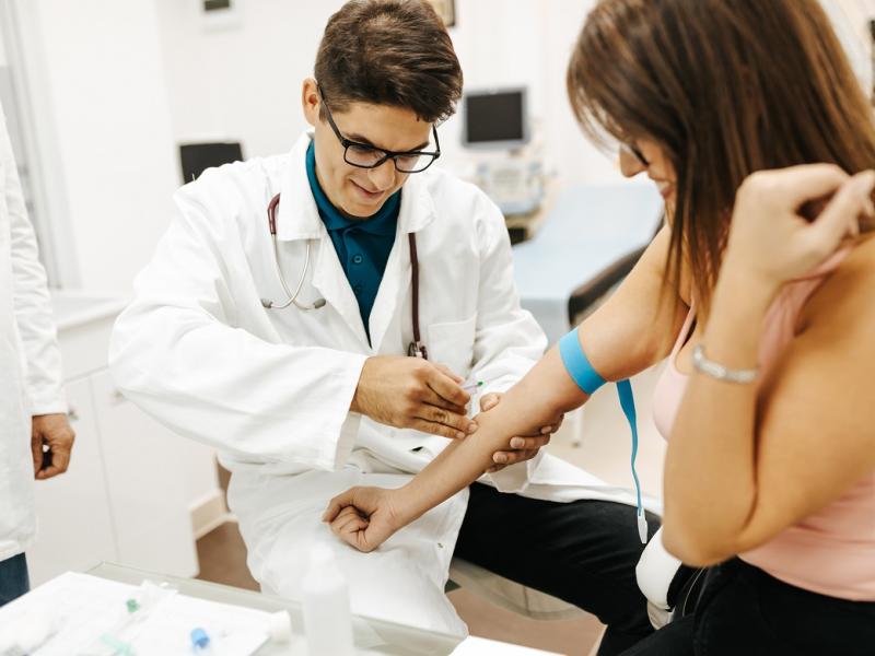 Doctor drawing blood from a patient