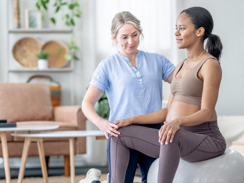 Pregnant woman training with physical therapist