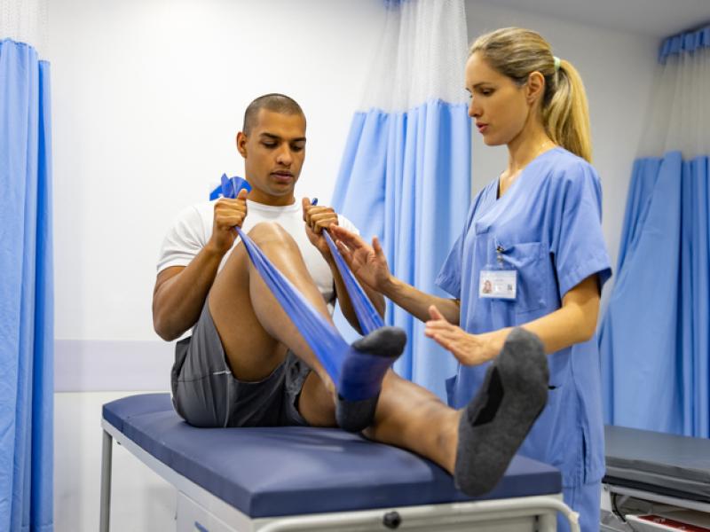 Physical therapy trainer training athlete