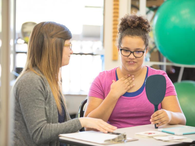 child with her therapist