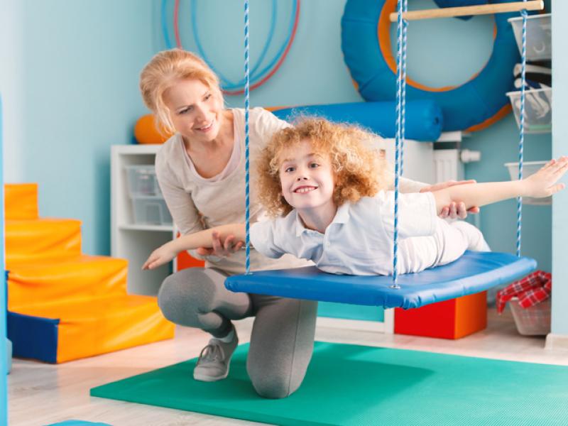 young boy with therapist