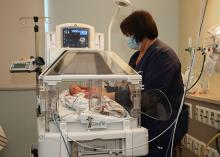 Deborah f sager neonatal intensive care unit inspira health nemours dupont pediatrics donation, nurse assisting to premature baby in bed