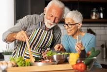 Elderly couple cooking together