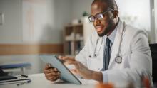 Black doctor on tablet