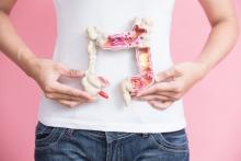 Woman holding intestine model