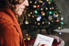 Woman writing down new year's goals