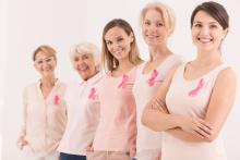 5 women wearing Breast Cancer awareness ribbons