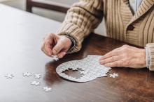 Old man completing puzzle 
