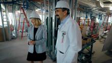 two people standing in construction area