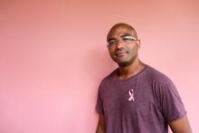 Male with pink breast cancer awareness ribbons on the man’s shirt