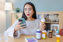 Woman holding a magnesium supplement bottle.