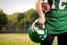 American football player holding ball