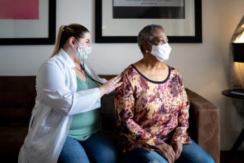 doctor checking patients lungs during exam