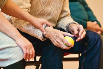 Elderly person holding stress ball