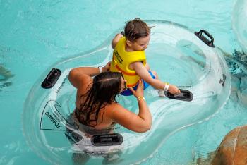 woman and child in lifevest in a double tube