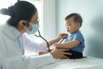 Asian female Doctor using stethoscope examining small Baby boy