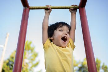 Beautiful Asian Japanese little boy having fun at playground