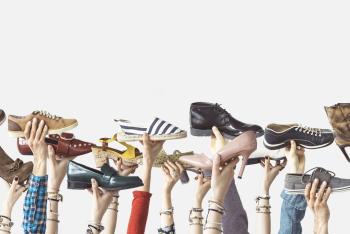Image of people holding shoes in the air